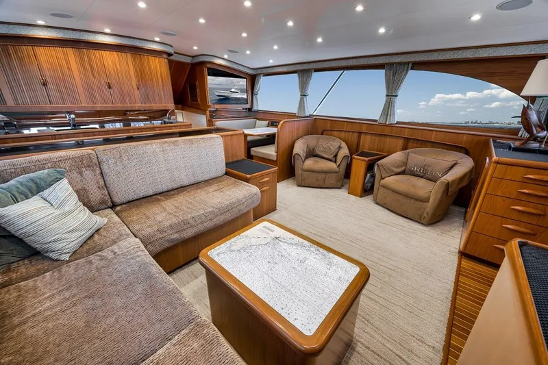 Slide: The Image of Luxurious interior of a 2001 Rybovich Sportfisherman yacht with plush seating and wooden accents. - 2