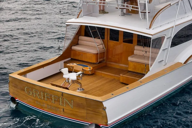 Slide: The Image of 2001 Rybovich Sportfisherman boat with wooden deck and seating, named "Griffin," on the ocean. - 25