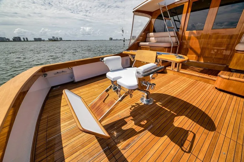 Slide: The Image of Luxurious 2001 Rybovich Sportfisherman yacht deck with polished wood and fishing chair. - 27