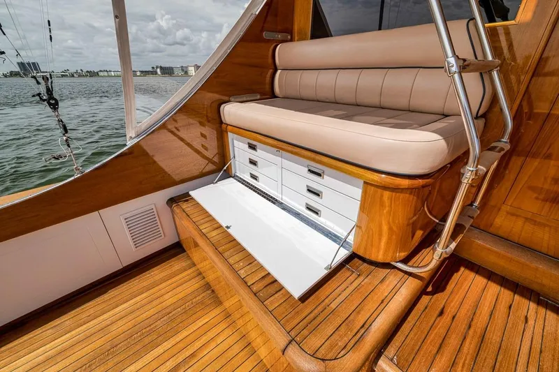 Slide: The Image of Luxurious 2001 Rybovich Sportfisherman boat interior with wooden deck and cushioned seating. - 29