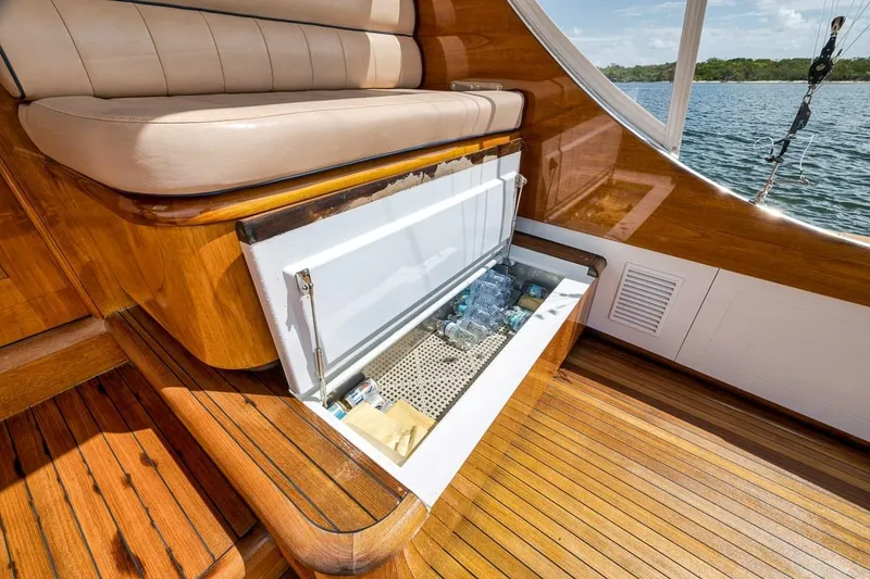 Slide: The Image of Luxurious 2001 Rybovich Sportfisherman boat interior with open storage compartment, wooden flooring, and scenic water view. - 30