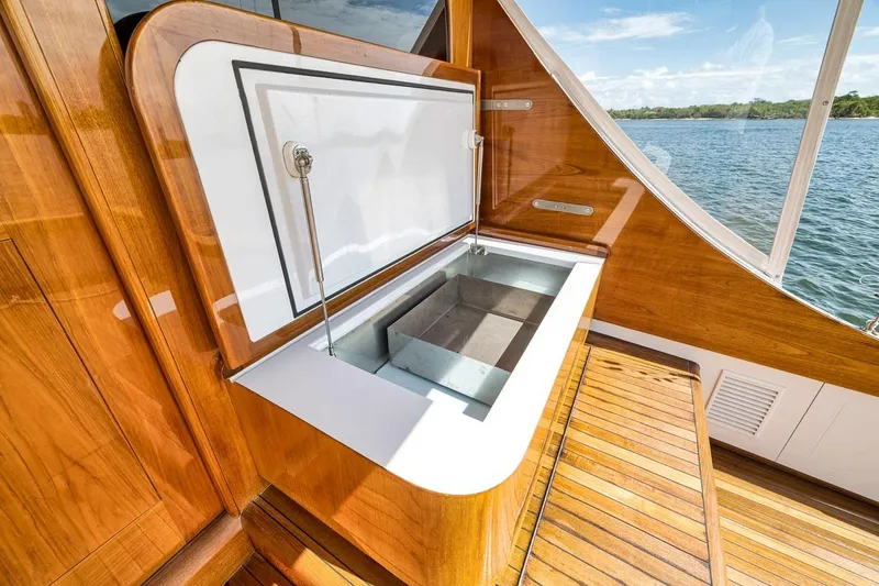 Slide: The Image of Luxurious 2001 Rybovich Sportfisherman yacht with open storage compartment, wooden deck, and scenic water view. - 31
