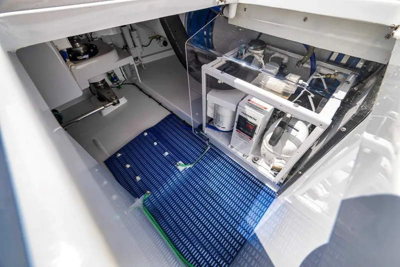 Slide: The Image of Engine room of a 2001 Rybovich Sportfisherman boat, showcasing mechanical components. - 34