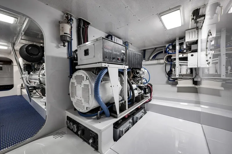 Slide: The Image of Engine room of a 2001 Rybovich Sportfisherman, featuring marine generator and equipment. - 39