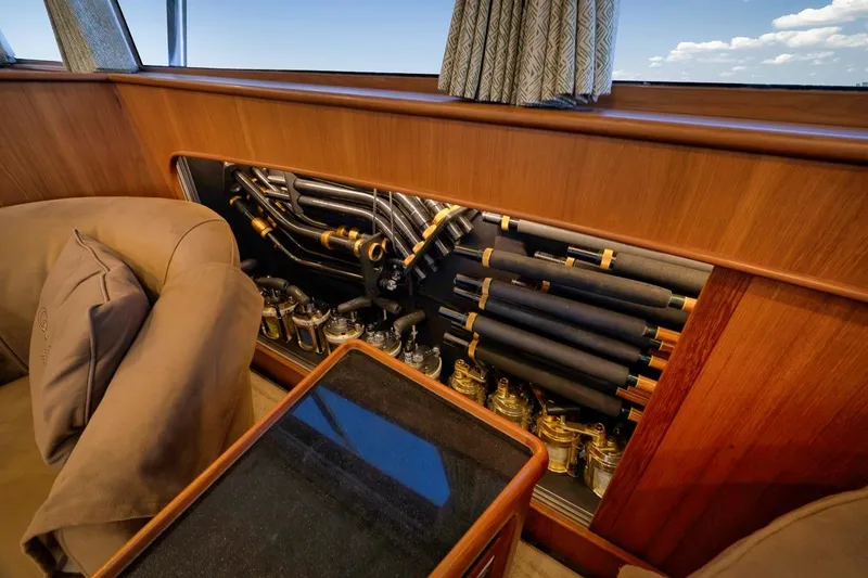 Slide: The Image of Interior of 2001 Rybovich Sportfisherman showcasing fishing rods and reels storage. - 4