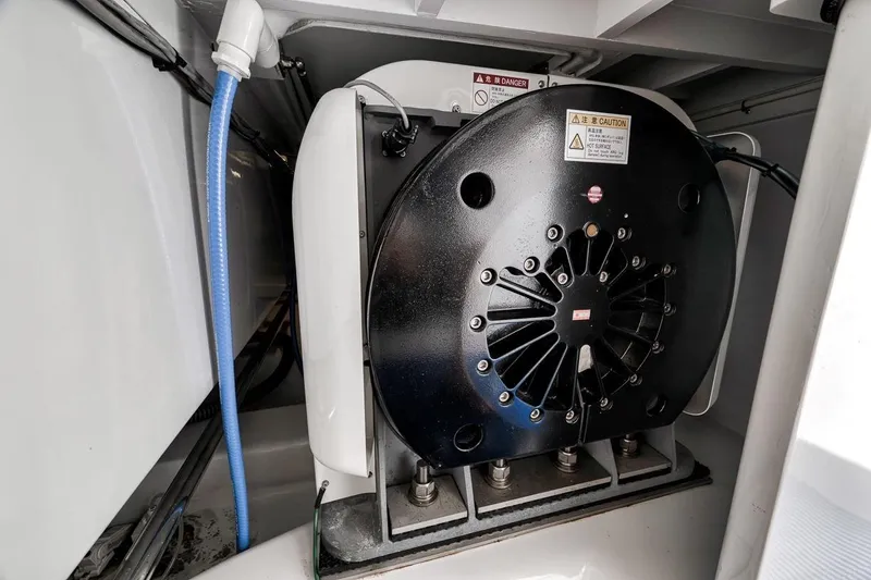 Slide: The Image of Engine compartment of a 2001 Rybovich Sportfisherman boat, featuring mechanical components. - 42