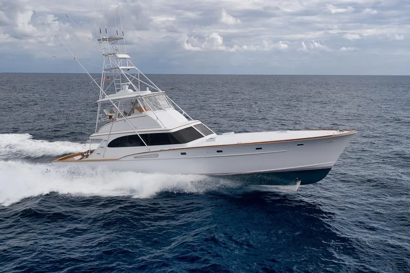 Slide: The Image of 2001 Rybovich Sportfisherman yacht cruising on open ocean under cloudy skies. - 45