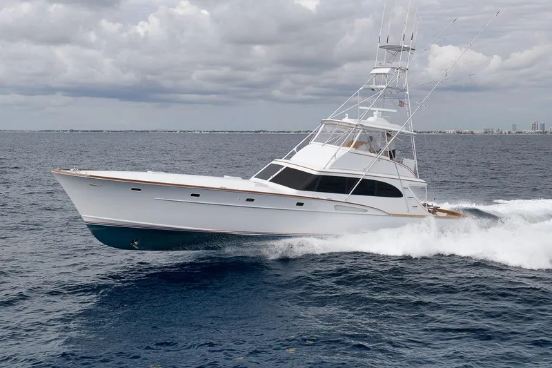 Slide: The Image of 2001 Rybovich Sportfisherman yacht cruising on open ocean under cloudy skies. - 46