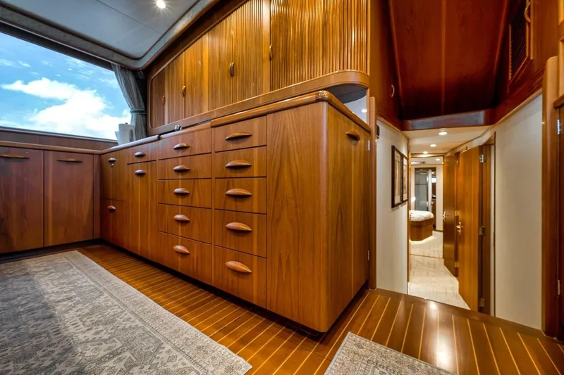 Slide: The Image of Luxurious wooden interior of a 2001 Rybovich Sportfisherman yacht, featuring ample cabinetry and elegant design. - 7