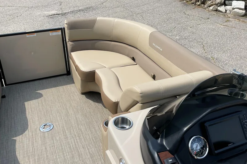 Slide: The Image of 2024 Veranda VR20RC pontoon boat with beige seating and modern dashboard. - 3