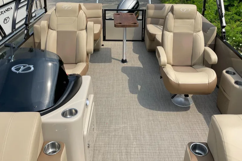 Slide: The Image of 2024 Veranda VR20RC pontoon boat interior with beige seating and a small table. - 4