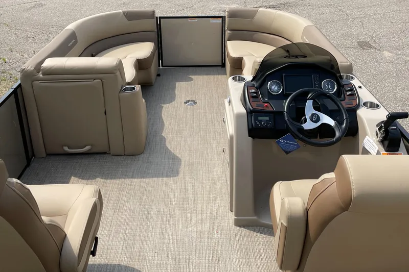 Slide: The Image of 2024 Veranda VR20RC pontoon boat interior with beige seating and modern dashboard. - 5