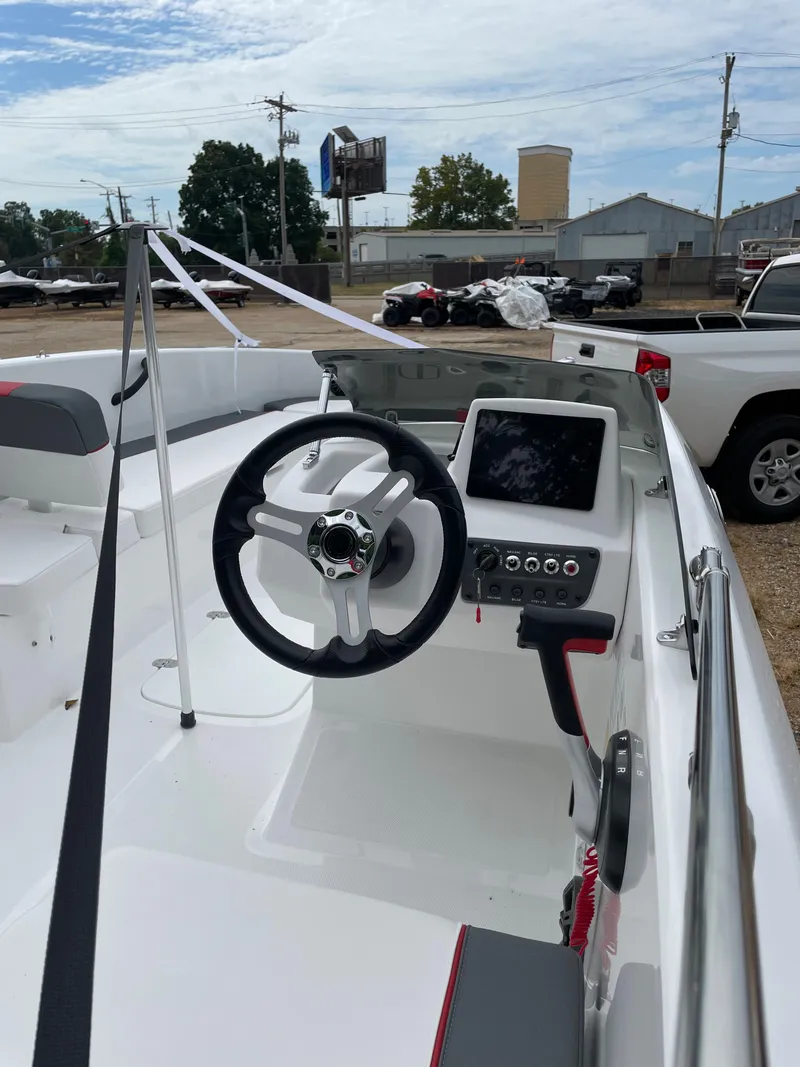 Slide: The Image of 2024 Tahoe T18 boat interior with steering wheel and control panel. - 6