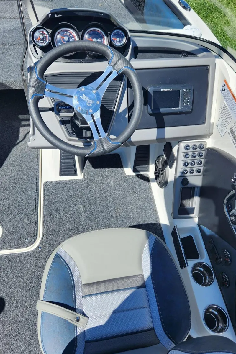 Slide: The Image of 2024 Ranger 1850MS boat cockpit with steering wheel, dashboard, and seating. - 4