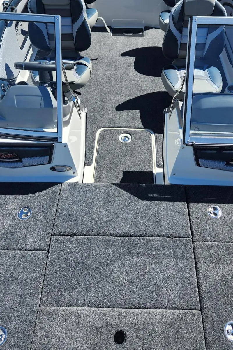 Slide: The Image of 2024 Ranger 1850MS boat interior with carpeted flooring and seating. - 6