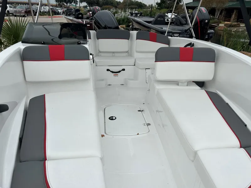 Slide: The Image of 2024 Tahoe T16 boat interior with white and gray seating, red accents, and storage compartments. - 4