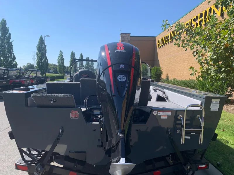 Slide: The Image of 2023 Ranger VX1788 WT boat with outboard motor, parked outdoors near a building. - 2
