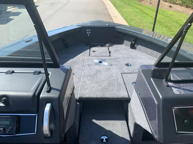 Slide: The Image of 2023 Ranger VX1788 WT boat interior with carpeted deck and storage compartments. - 7