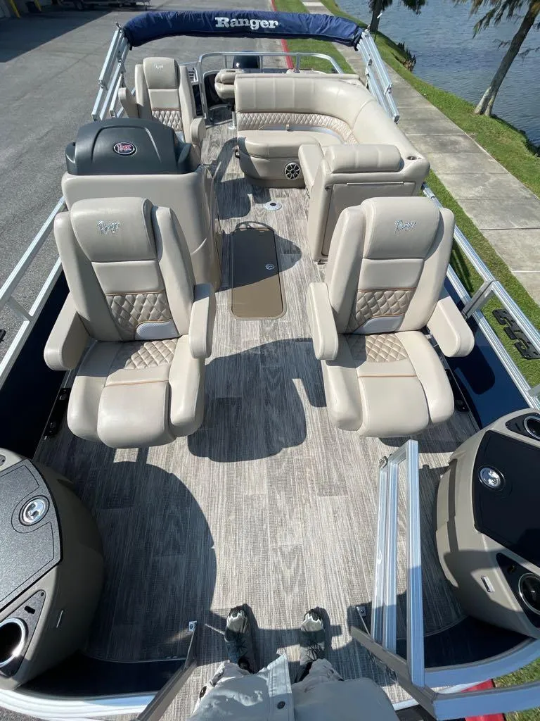 Slide: The Image of 2024 Ranger Reata 223F boat interior with luxurious seating and modern design. - 2