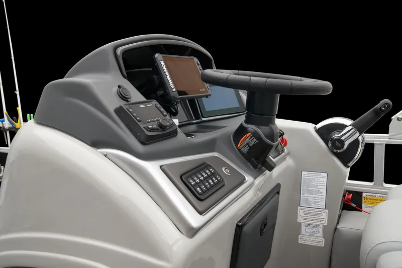Slide: The Image of 2024 Ranger Reata 223F boat console with steering wheel and electronic controls. - 37
