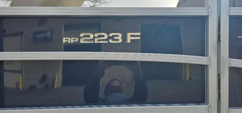 Slide: The Image of 2024 Ranger Reata 223F boat model nameplate on reflective surface. - 4