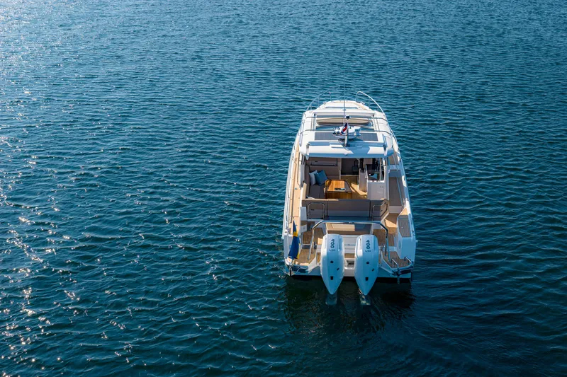 Slide: The Image of 2024 Nimbus Weekender 11 boat on open water, rear view. - 34