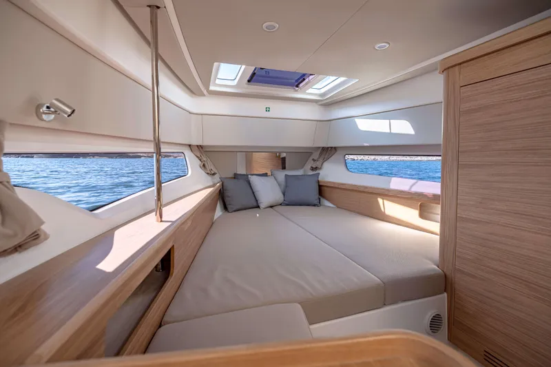 Slide: The Image of Luxurious interior of 2024 Nimbus Weekender 11 yacht with cozy bed and scenic windows. - 49