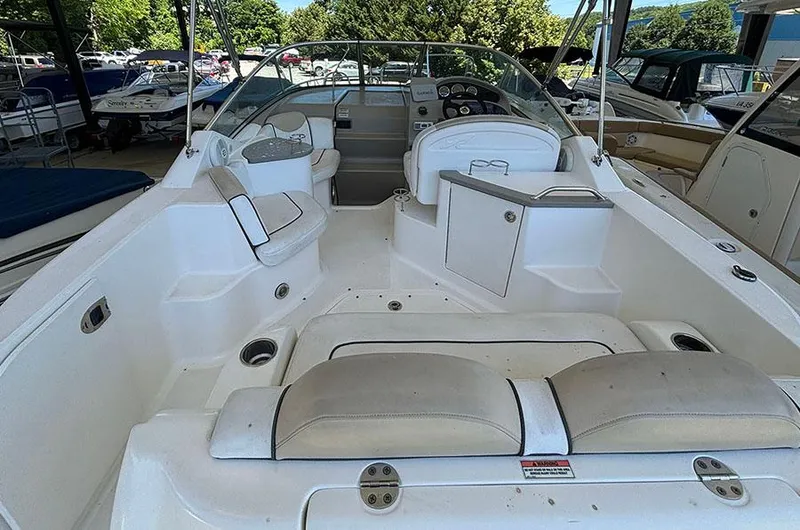 Slide: The Image of 2008 Sea Ray 240 Sundancer boat interior with seating and helm. - 10