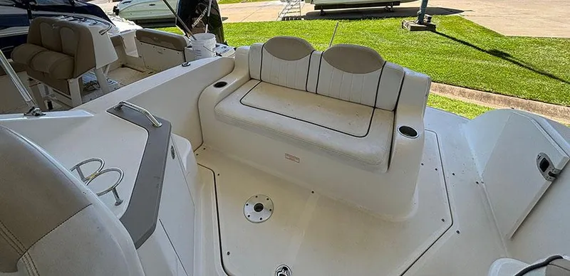 Slide: The Image of 2008 Sea Ray 240 Sundancer boat interior with seating and cup holders. - 11