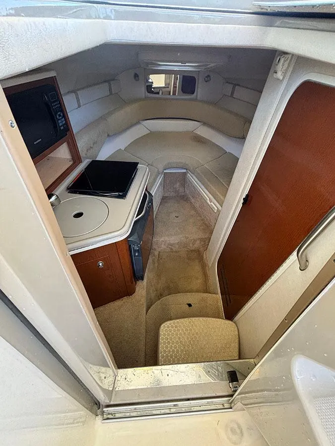 Slide: The Image of Interior cabin of 2008 Sea Ray 240 Sundancer with kitchenette and seating area. - 13