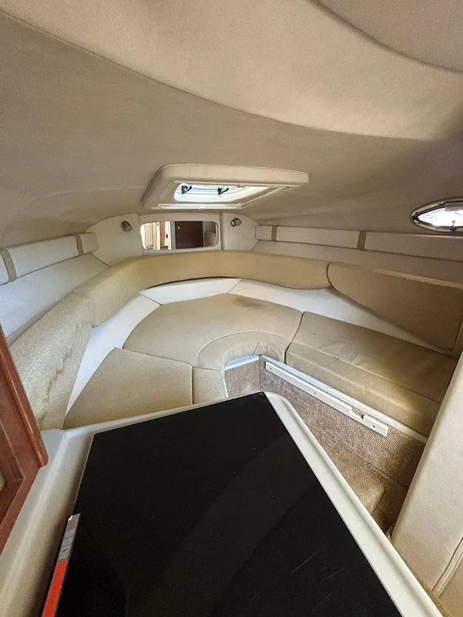 Slide: The Image of Interior cabin of 2008 Sea Ray 240 Sundancer boat with beige seating. - 14