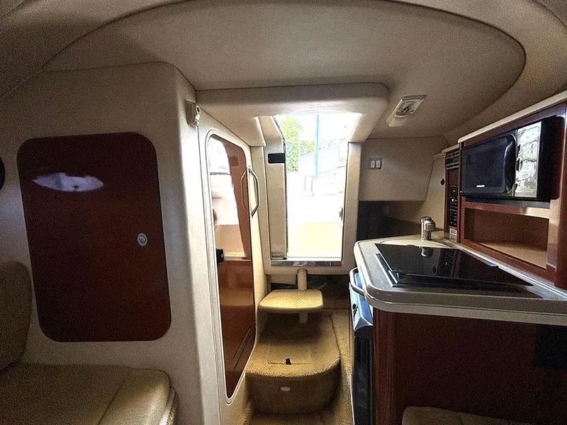 Slide: The Image of Interior cabin of 2008 Sea Ray 240 Sundancer with kitchenette and seating area. - 15