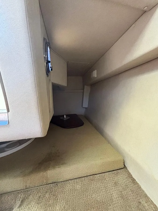 Slide: The Image of Interior cabin of 2008 Sea Ray 240 Sundancer boat with beige upholstery. - 20