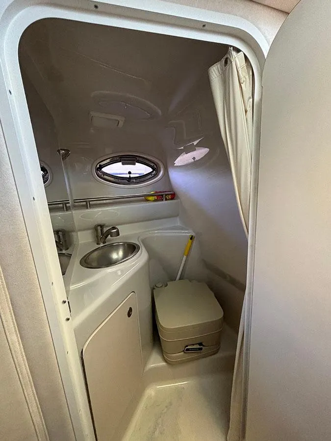 Slide: The Image of 2008 Sea Ray 240 Sundancer boat bathroom with sink and toilet. - 21