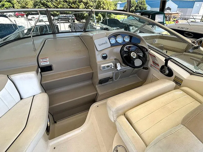 Slide: The Image of 2008 Sea Ray 240 Sundancer boat cockpit with Garmin navigation system and beige seating. - 8