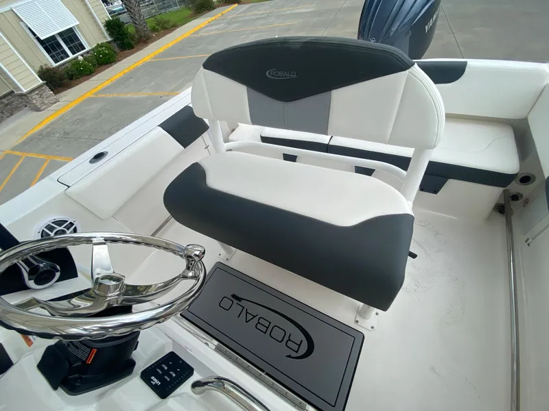 Slide: The Image of 2026 Robalo 202 EXPLORER boat interior with steering wheel and seating. - 11