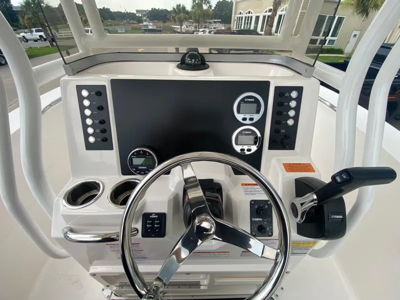 Slide: The Image of 2026 Robalo 202 EXPLORER boat dashboard with steering wheel and control panel. - 12