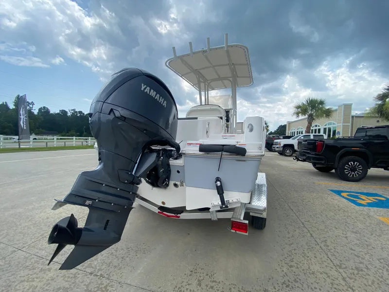 Slide: The Image of 2026 Robalo 202 EXPLORER boat with Yamaha outboard motor, parked outdoors. - 3