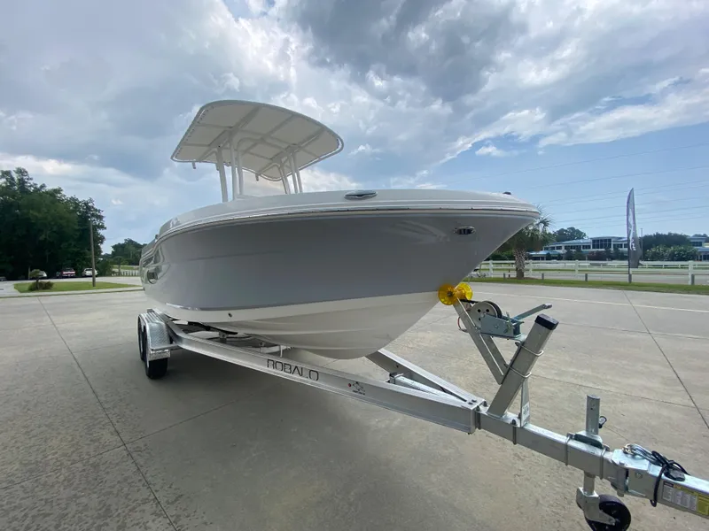 Slide: The Image of 2026 Robalo 202 EXPLORER boat on trailer under cloudy sky. - 4