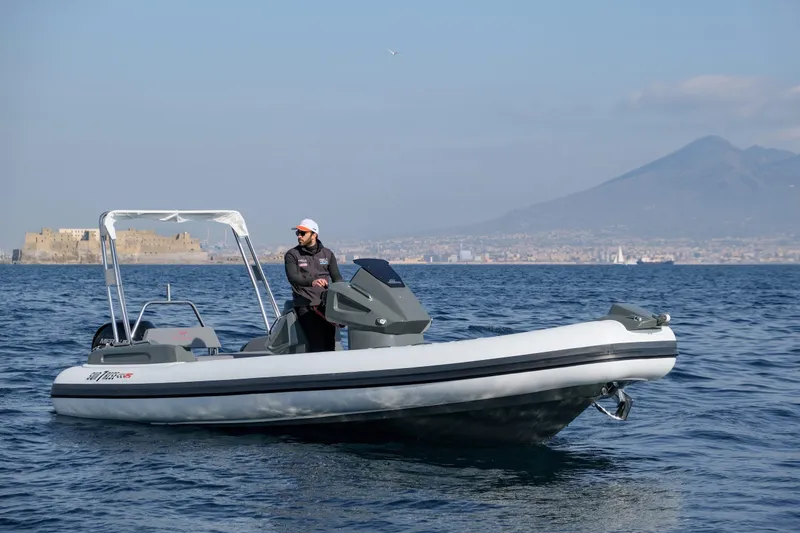 Slide: The Image of Custom Sunrise 24 boat on water with scenic mountain backdrop, 2024 model. - 3