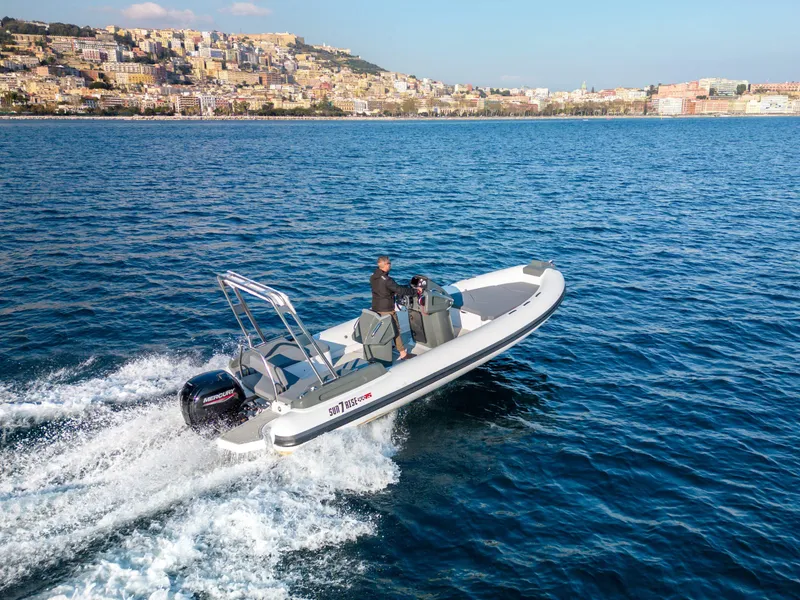 Slide: The Image of Custom Sunrise 24 boat cruising on blue water near coastal city, 2024 model. - 5