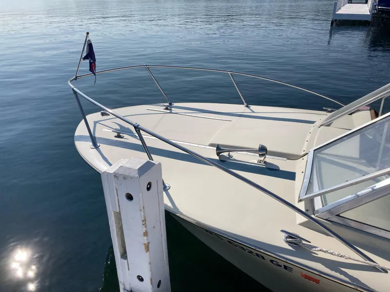 Slide: The Image of 1970 Chris-Craft Lancer 23 boat docked on calm water. - 11