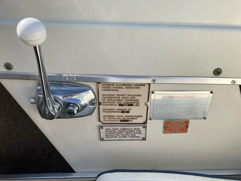 Slide: The Image of 1970 Chris-Craft Lancer 23 control panel with throttle and safety instructions. - 15