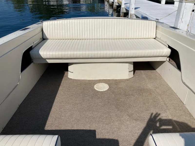 Slide: The Image of Vintage 1970 Chris-Craft Lancer 23 boat interior with white seating and carpeted floor. - 18
