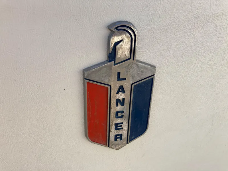 Slide: The Image of 1970 Chris-Craft Lancer 23 emblem with red and blue accents. - 19
