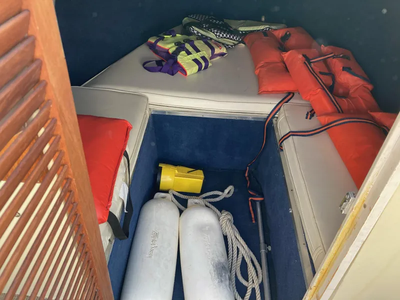 Slide: The Image of 1970 Chris-Craft Lancer 23 cabin with life jackets and boating equipment. - 20