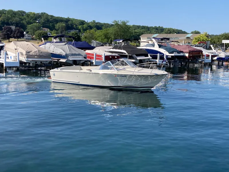 Slide: The Image of 1970 Chris-Craft Lancer 23 boat docked in a marina with other boats. - 5