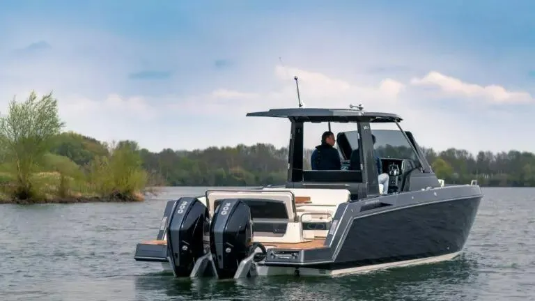 The Image of 2025 Schaefer V33 boat with dual outboard engines on a lake. - 0