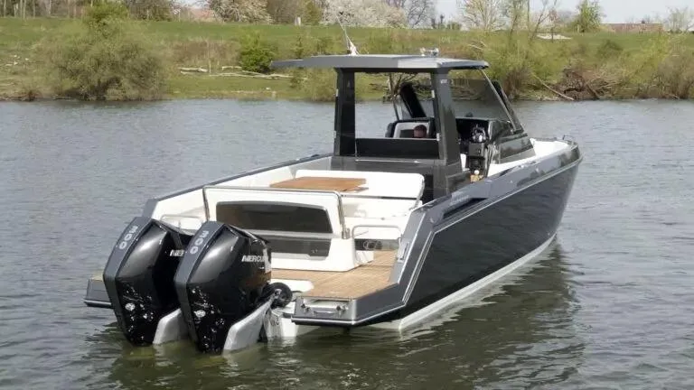 Slide: The Image of 2025 Schaefer V33 boat with dual Mercury outboard engines on a calm lake. - 2