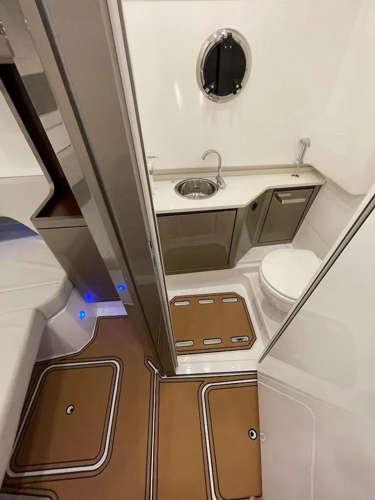 Slide: The Image of Modern bathroom in 2025 Schaefer V33 boat with sink, toilet, and porthole window. - 31